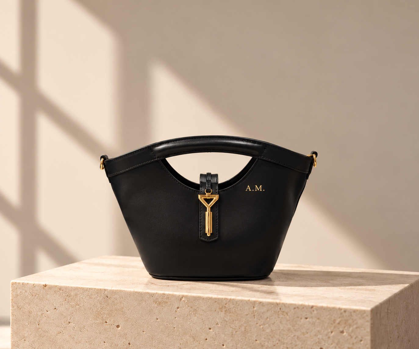 Black Florian leather tote bag on a travertine plinth