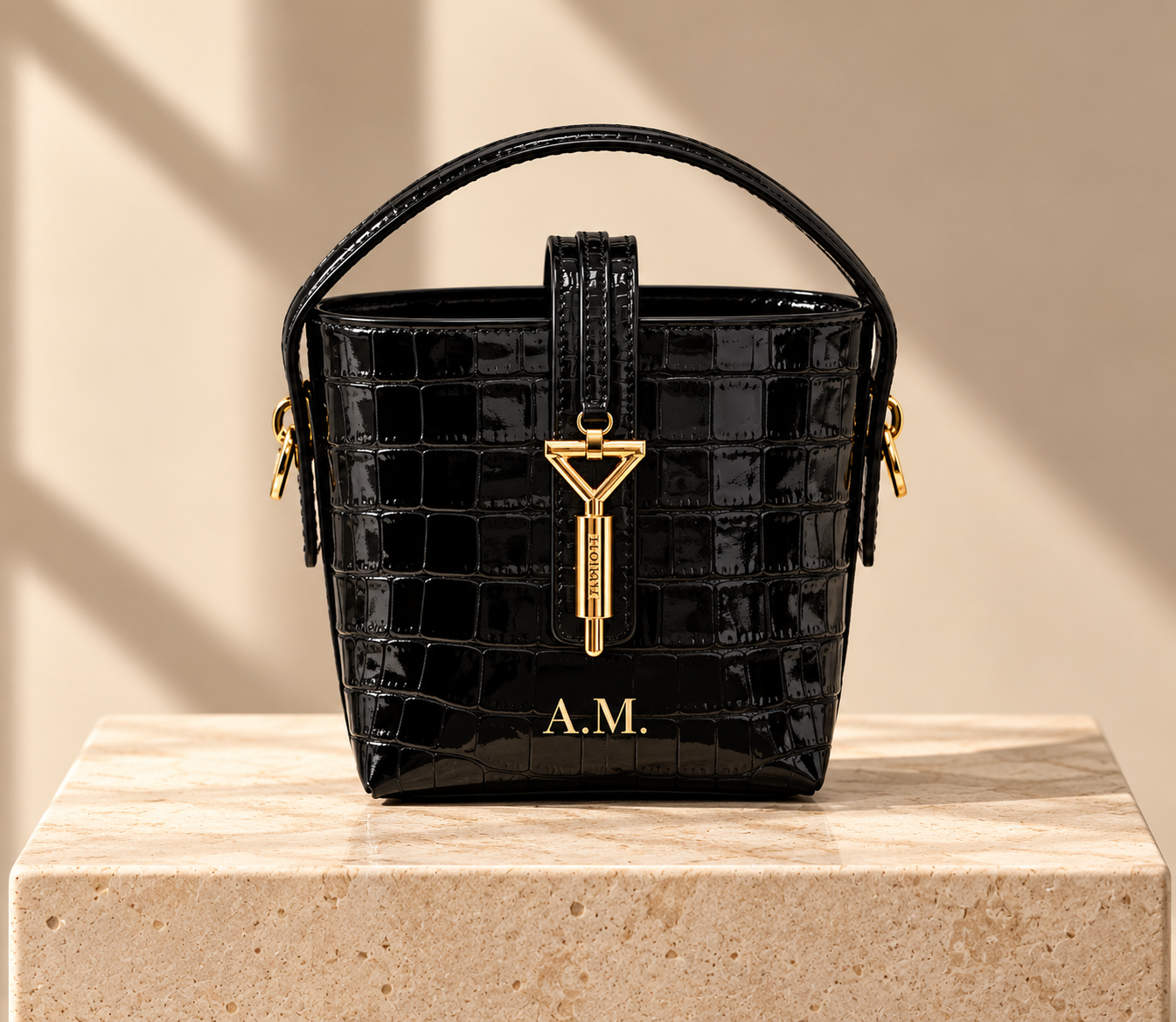Black Florian handbag displaying gold foil initials A.M.